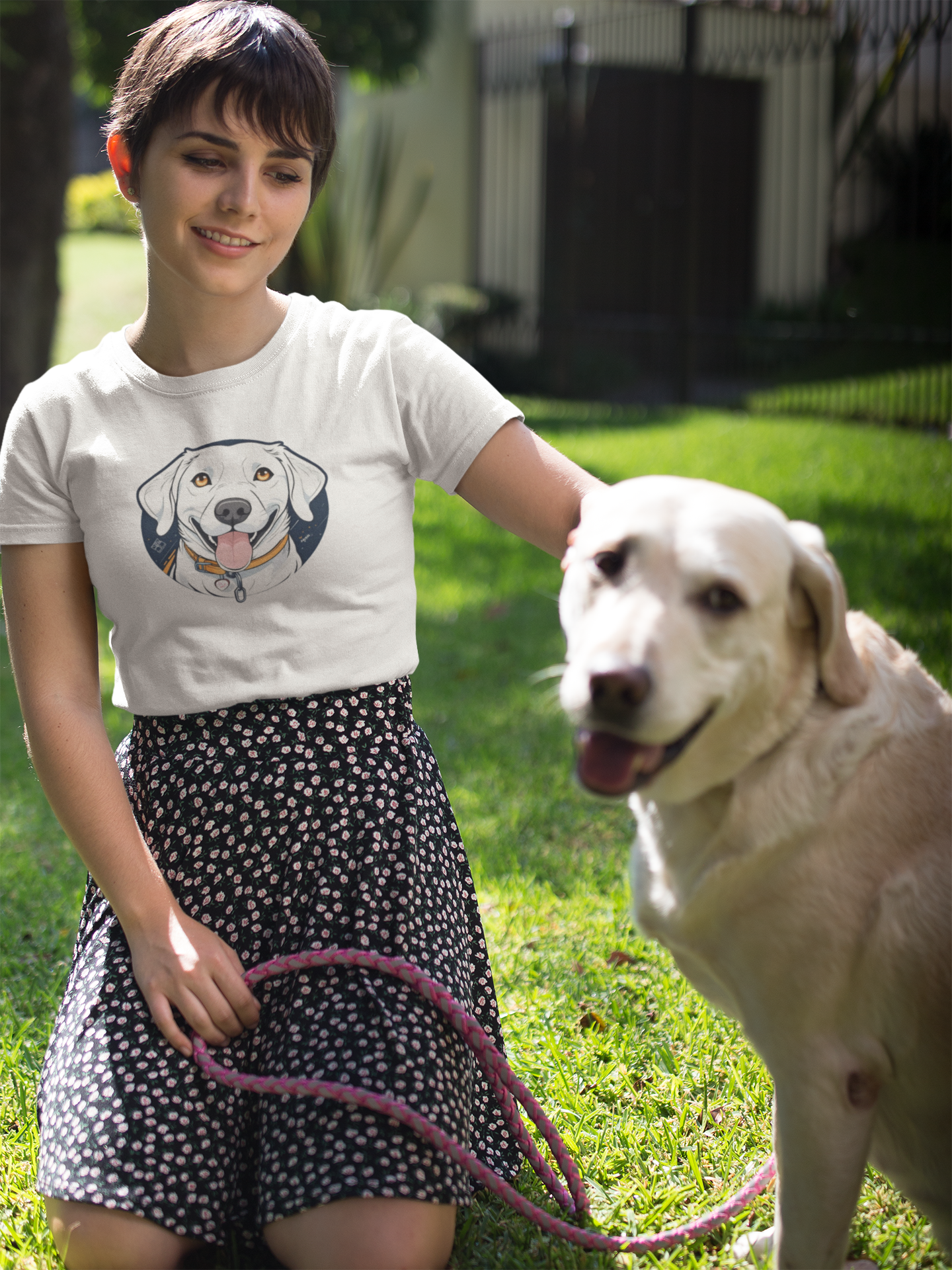 Woman with golden retriever wearing white t-shirt with dog print
