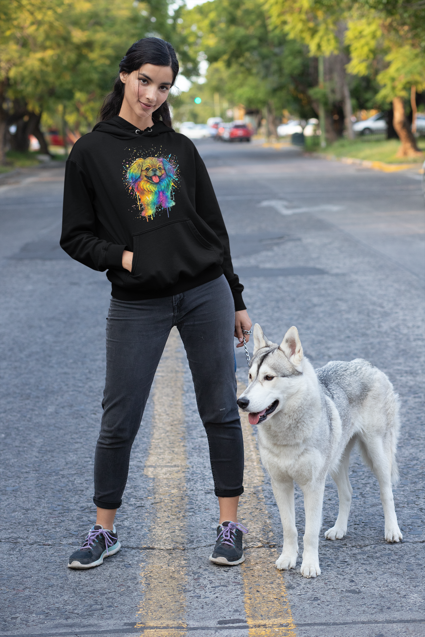 Woman with dog wearing black hoodie with colorful dog print
