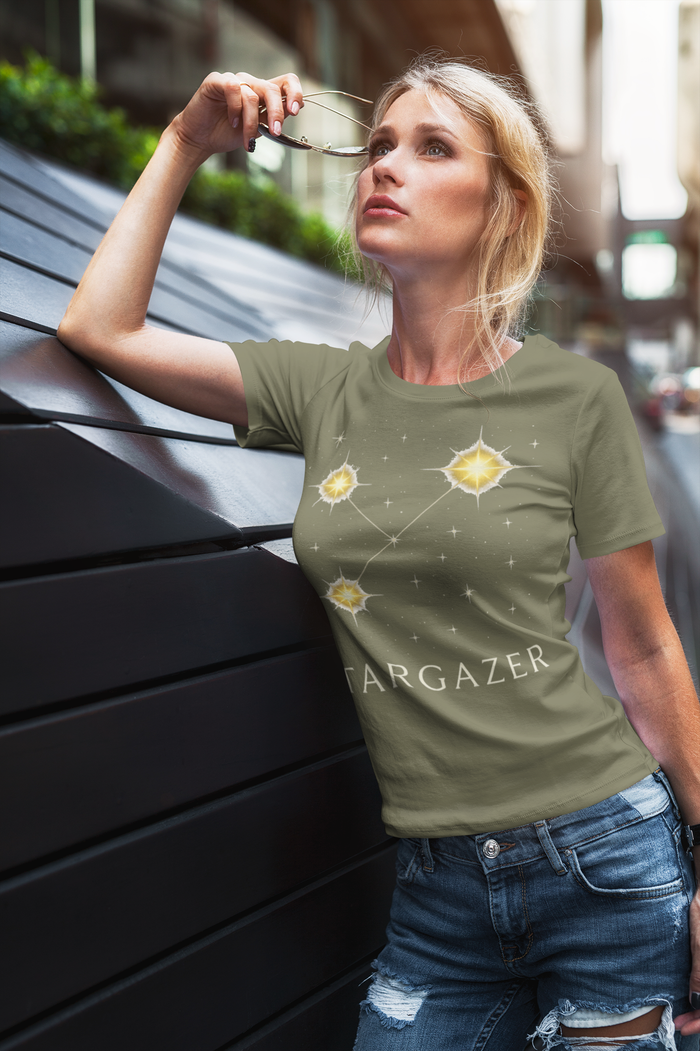 Woman wearing khaki t-shirt with constellation print
