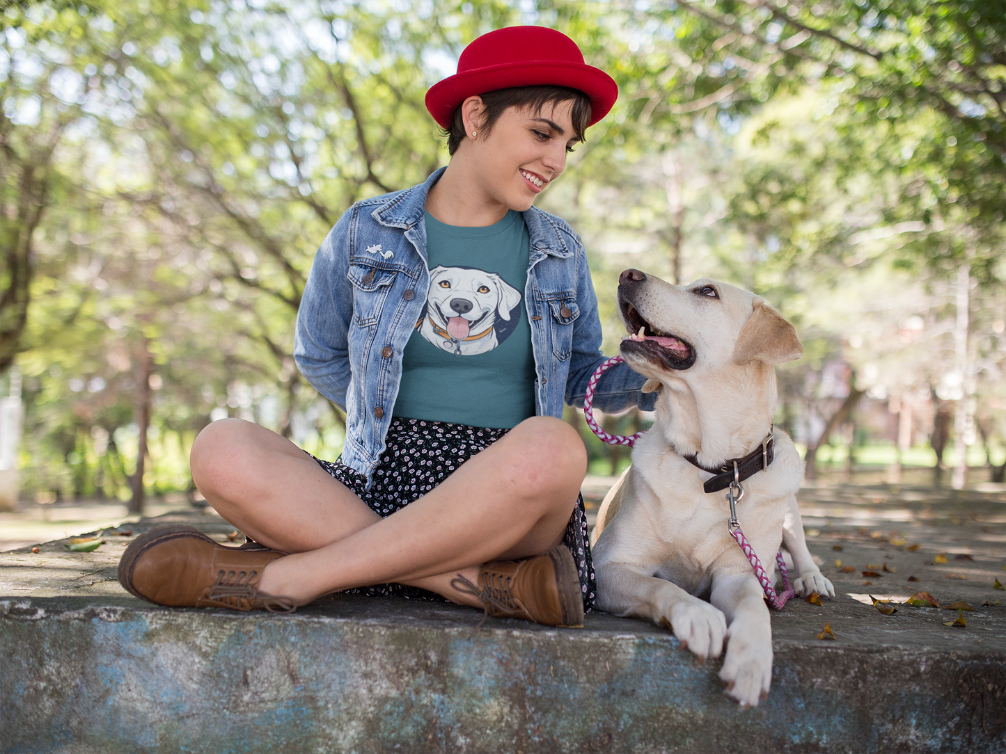 Woman with golden retriever wearing teal t-shirt with dog print

